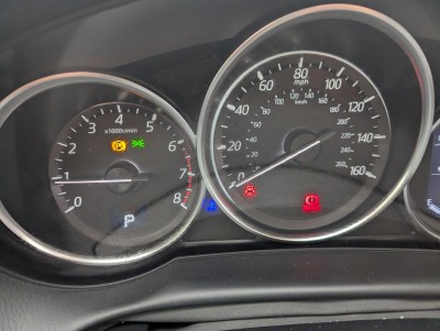 Vehicle dashboard with warning lights visible