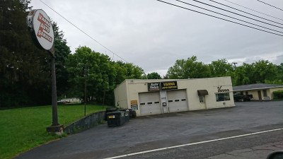 Roadside angle of Varna Auto Service with the Auto Value sign